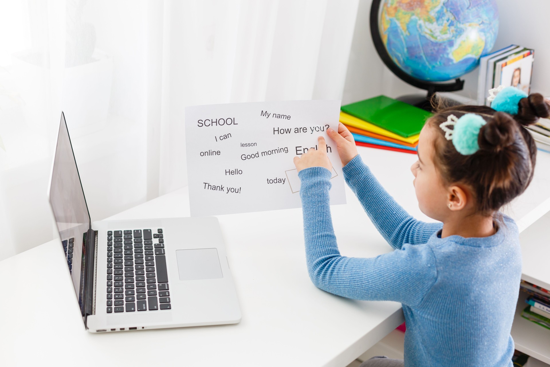 English distance learning for kids. Homeschooling and distance learning for children. Girl student study online with video call teacher.